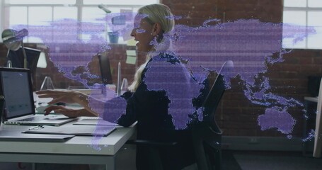 Typing blonde woman in dark blazer working on laptop at open office, with purple world-map overlay