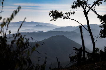 Fototapeta premium Foggy sunrise over the Cordillera de la Costa mountain range in Miranda State, Venezuela. Guarenas and Guatire
