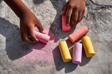 Chalk Drawing - Hands Holding Colorful Chalk Sticks on Pavement - Capturing Creative Childhood