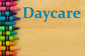Daycare child care education concept with crayons on wood desk
