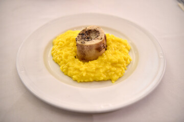 Risotto alla milanese con ossobuco or Milanese risotto with braised veal is typical food from Milan and Lombardy region in Italy