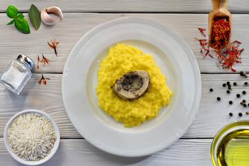 Risotto alla milanese con ossobuco or Milanese risotto with braised veal is typical food from Milan and Lombardy region in Italy