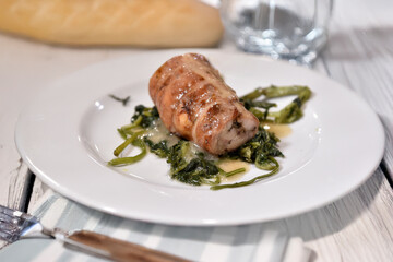Roll&egrave; di coniglio in porchetta whit chicory or stuffed rabbit rolls is typical food from  Rome and Lazio region in Italy