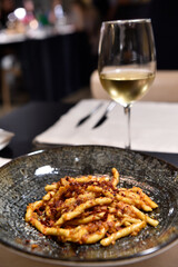 Bigoli whit peperoni cruschi and caciocavallo cheese is typical food Basilicata in italy