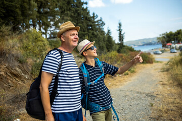 Summer hiking trip with father and teenage son. Active family time, trust, and connection while exploring nature, suitable for commercial and lifestyle use.