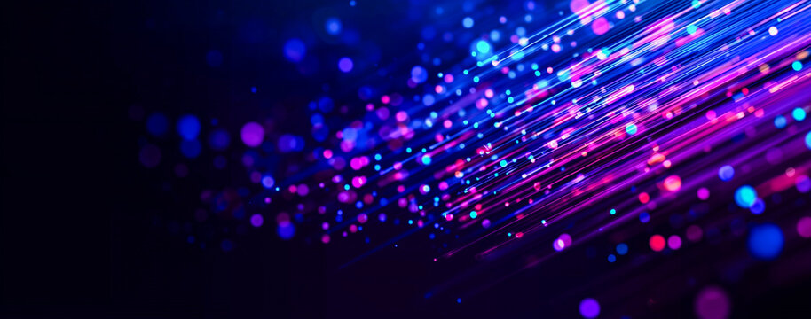 Abstract background of neon glowing light trails and bokeh spheres in pink, blue, and purple colors. High speed motion lines on dark background with shallow depth of field.