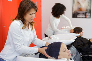 Obraz premium hairdresser wrapping clients hair in towel