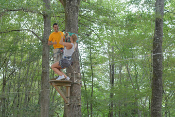 adults on adventure course through the trees