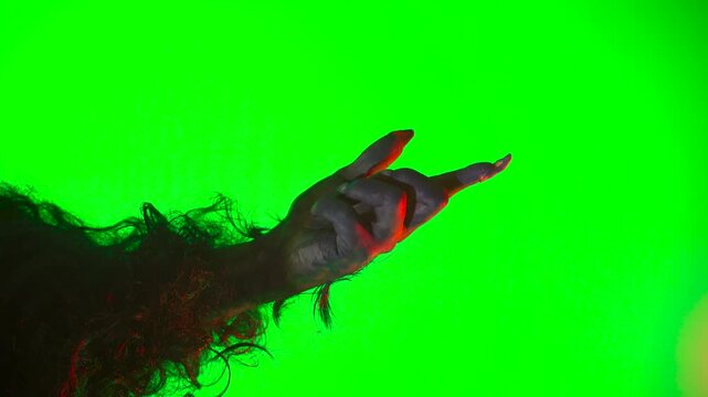 a scary hand with claws, a wolf's paw, a werewolf's paw, a monster's paw, and a gesture of summoning on a green background