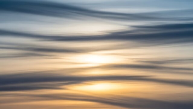 Bright sun shines through scattered clouds and contrails creating a dynamic atmospheric display above high quality