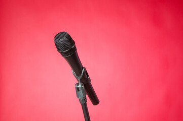 Wireless microphone with stand on a red background