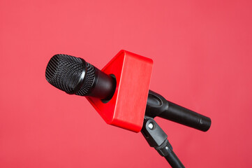Wireless microphone with stand on a red background