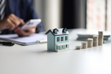 Investing in Real Estate, Real estate agent or investor calculating, planning, analyzing financial data for property investment. Themes of saving, investing, financial aspects of purchasing a home.