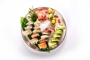 Top view of Japanese sushi set with assorted rolls on a white background with copy space, ideal for food advertising, restaurant menu design and promotional banners.