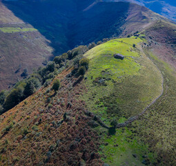 Aerial drone view of the landscape around San Pedro del Romeral. Pas-Miera region. Pasiegos Valleys. Cantabria. Spain. Europe