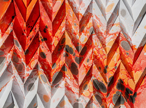 Folded Japanese origami on marbling background texture, abstract geometric pattern artwork, multidimensional colorful artwork