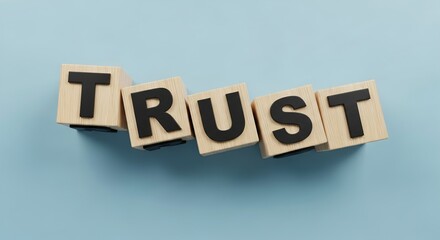 Wooden blocks spelling out the word TRUST on a light blue background, symbolizing reliability and confidence.