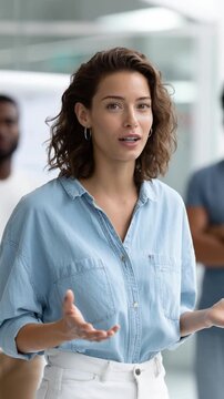 Confident and enthusiastic female CEO giving a motivational speech to her team. She speaks with passion and energy, inspiring employees and promoting teamwork, leadership