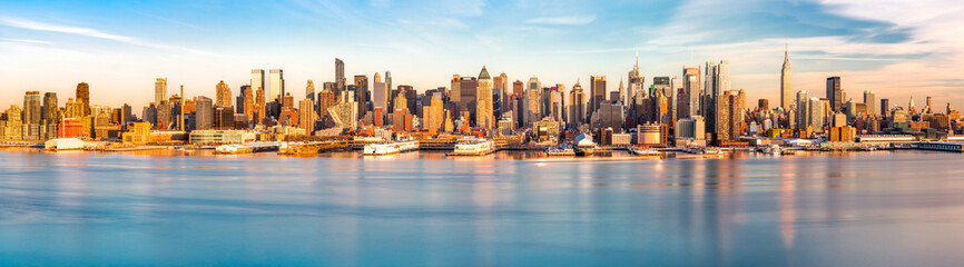 New York City Panorama as viewed from New Jersey across Hudson River. The last sunrays before sunset cast an orange glow on the skyscraper's facades