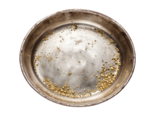 Panning for gold in a rustic metal pan isolated on transparent or white background, png
