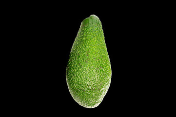 Ripe avocado, isolated on black background, close-up.