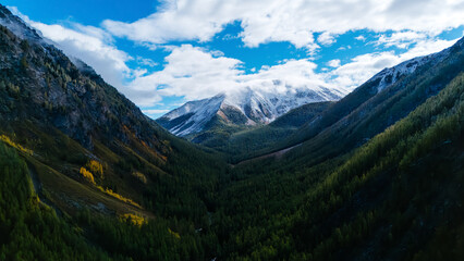 mountain peaks in the Altai region covered with the first snow in autumn, as seen from a drone