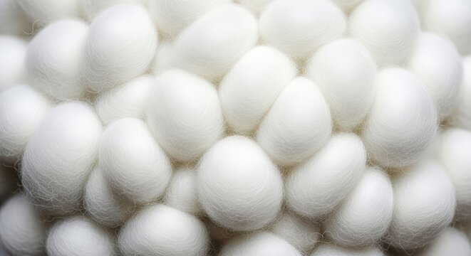 Close-up macro view of a dense cluster of fluffy white silkworm cocoons