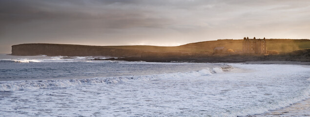 sunrise over beach with sea Spray 
