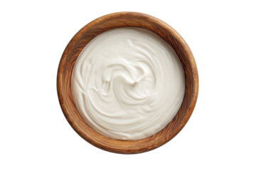 Creamy white yogurt swirl in a wooden bowl isolated on transparent background. Creamy yogurt swirl in a rustic wooden bowl isolated on white background.