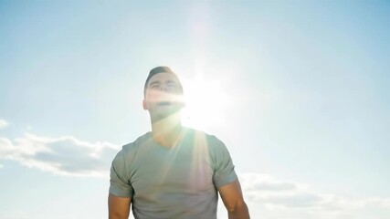 Joyful celebration under sunny skies: man's triumphant journey from elation to contentment