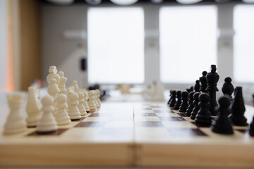 Chess pieces poised for battle in a bright, modern setting