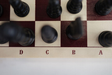 Chess pieces poised on the board, ready for a strategic showdown in a cozy setting
