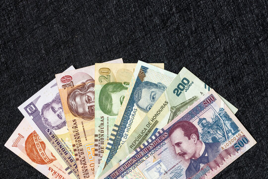 Honduras money. Paper banknotes, Hondurian lempiras bills arranged in a fan on a black background. Financial business concept. Flat lay, copy space. Close up