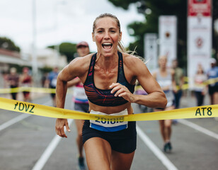 A woman crossing the finish line of a local race, exhaustion mixed with immense happiness.

