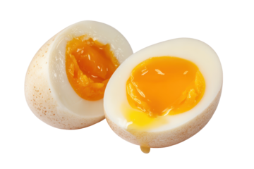Soft boiled egg with bright orange yolk isolated on transparent background. Soft boiled egg sliced in half showing runny yolk isolated on white background.