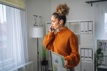 Fototapeta premium Woman experiencing work stress during a phone call