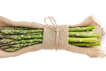 Bundle of fresh green asparagus tied with twine isolated on transparent background. Close-up of a fresh raw asparagus bunch tied with a burlap twine isolated on a white background.