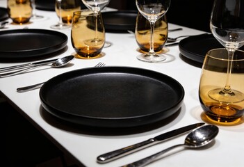 Elegant Table Setting with Black Plates and Amber Glassware