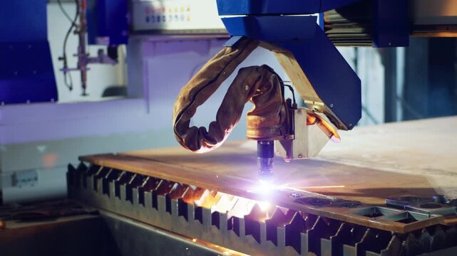 Automatically heavy industrial machinery cut off and welding the metal in the metalwork manufacturing factory