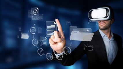 A man wearing a virtual reality headset engages with a holographic digital interface, demonstrating advanced technology and interactive experiences in a contemporary workspace. Raster