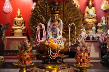 Ornate Chinese Temple Deity Statue With Offerings and Ritual Decor