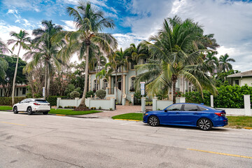 Sunny tropical neighborhood with palm trees and residential houses in Key West