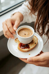 Close-up of a woman's arm holding a cup of coffee
