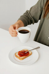 Close-up of a woman's arm holding a cup of coffee