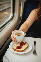 Close-up of a woman's arm holding a cup of coffee