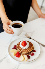 Woman having breakfast in the kitchen