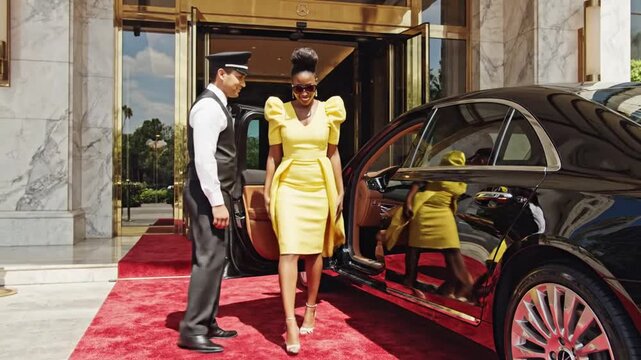 Chauffeur opens luxury car door for woman exiting hotel with red carpet