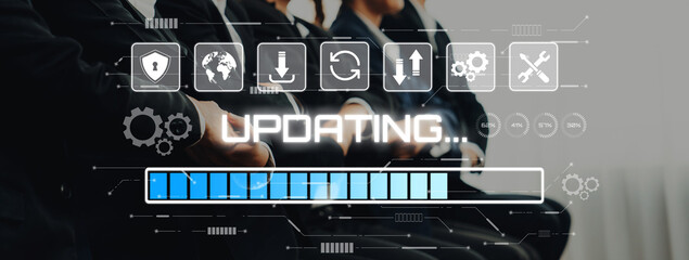 Professional business team collaborates in a modern office environment while technology graphics indicate updates and progress through digital icons and visuals. Trope