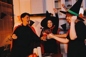 Friends enjoying a Halloween party at a bar making a toast