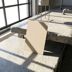 Minimalist beige card on concrete surface with natural light and shadows.